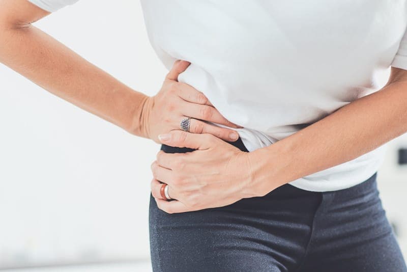A person holding a painful hip